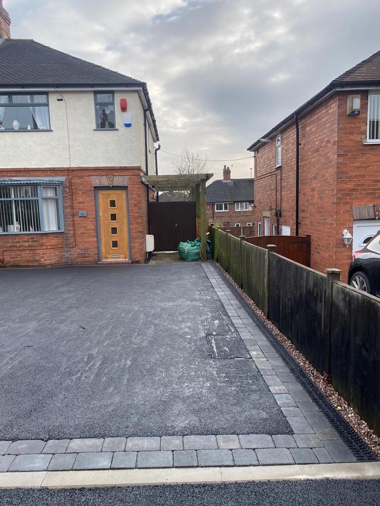 Tarmac driveway with block paved edging and a drainage channel